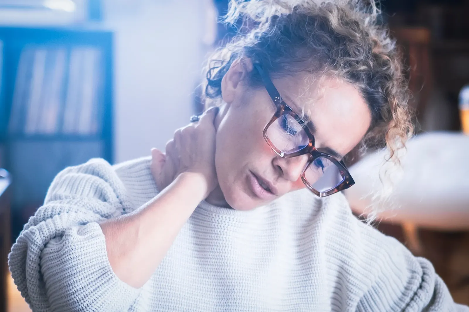 Woman holding her sore neck after an injury